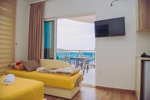 a living room with a couch and a tv at Apartments Krstovic in Sutomore