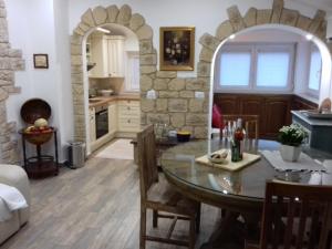 a kitchen and dining room with a table and chairs at Apartment Fritula Istriana in Koper