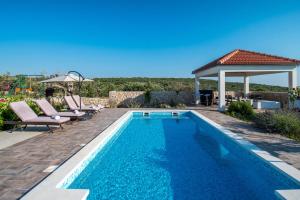a swimming pool in a backyard with a gazebo at Villa Daly in Primošten