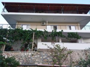 a white building with plants on the side of it at Apartments Aneta's House in Himare