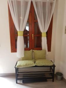 a couch in front of a window with curtains at Casa Ponet in Valencia de Aneu