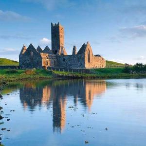 an old castle sitting on top of a body of water at THISTLEDOWN - Ballina - Crossmolina - County Mayo - Sleeps 8 - Sister property to Inglewood in Ballina