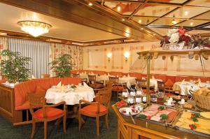 a restaurant with tables and chairs in a room at Burghotel in Geislingen an der Steige