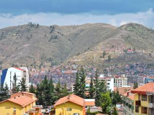 a view of a city with a mountain in the background at Hostal La Nuit in Cusco