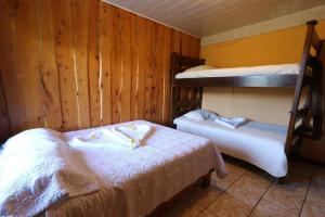 two bunk beds in a room with wooden walls at Mora's Place B&B in Monteverde Costa Rica