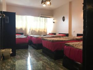 A bed or beds in a room at Wake Up! Cairo Hostel