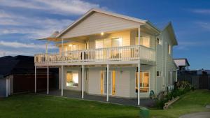 a large house with a balcony on top of it at Rocks Beach House Victor Harbor in Hayborough