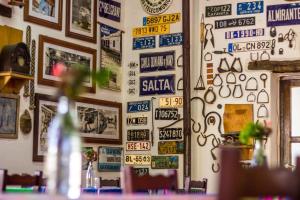 a wall with lots of signs on it at El Hospedaje in Cafayate