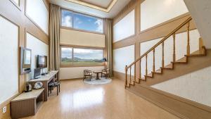 a large room with a staircase and a large window at Venezia Hotel in Suncheon