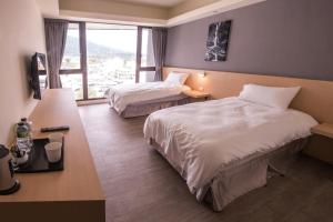Postelja oz. postelje v sobi nastanitve KET Hotel