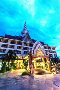 a large building with a restaurant in front of it at Smiling Deluxe Hotel in Siem Reap