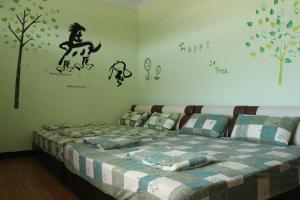 Llit o llits en una habitació de 驫風民宿 Equuleus Homestay