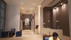 a man sitting in the lobby of a store at Khalil's Horizons 101 Studio Type Condominium in Cebu City +46 photos