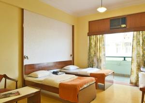 Postel nebo postele na pokoji v ubytování Sea Green Hotel