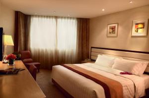 Voodi või voodid majutusasutuse Grandview Hotel Macau toas