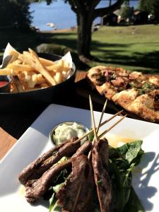 a plate of food with french fries and a pizza at The Long View Lodge in Long Lake