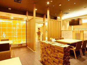 a restaurant with a table and chairs and a counter at Hotel New Otani Takaoka in Takaoka