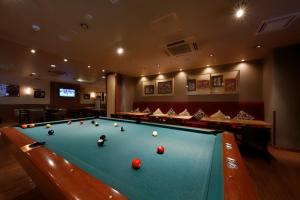a billiard room with a pool table with balls on it at Welco Narita in Narita