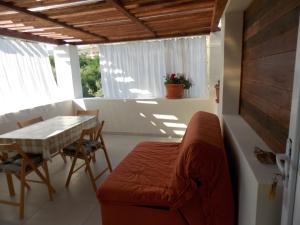 a living room with a couch and a table at Rocco apartments in Pag