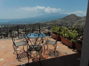a table and chairs on a balcony with a view at Villa Sara in Taormina