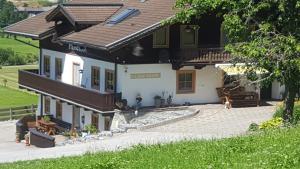 a large house with a courtyard in front of it at Fasserhof in Bramberg am Wildkogel