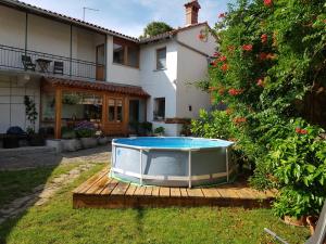 a pool sitting on a deck in front of a house at Vila Dane in Sežana