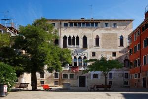 un grand bâtiment en briques avec un balcon dans une ville dans l'établissement Hotel La Residenza, à Venise