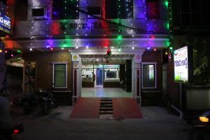 a building with purple and green lights on it at Hotel Garuda Guntur in Guntūr