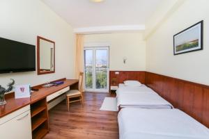 Postel nebo postele na pokoji v ubytování Hotel Merlot
