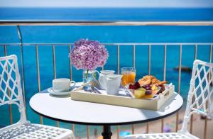 a table with a tray of food on a balcony at Hotel Costa Brava in Platja  d'Aro