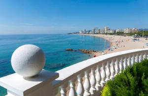 a balcony with a view of a beach and the ocean at Hotel Costa Brava in Platja d'Aro