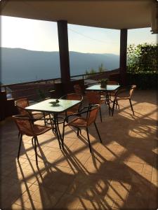 two tables and chairs on a patio with a view at Apartmani Labovic in Budva