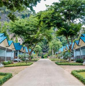 a road leading to a row of houses with trees at Changsi Resort-Krabi in Krabi town