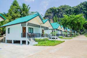 a row of houses with trees in the background at Changsi Resort-Krabi in Krabi town