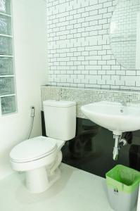 a bathroom with a white toilet and a sink at Changsi Resort-Krabi in Krabi town