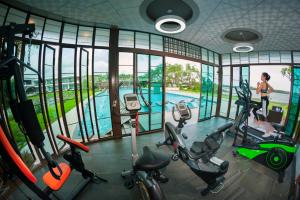 a gym with a view of a swimming pool at Baan Rim Ao in Chanthaburi