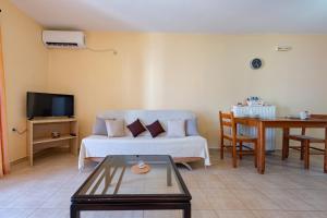 a living room with a couch and a table at La Casa Di Nonna in Argostoli