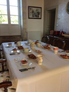 a white table with food on it at le Logis du Plessis in Chaniers +27 photos