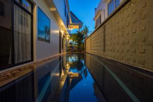 a swimming pool in the middle of a building at Boravin House in Siem Reap