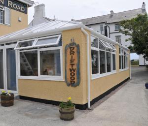 a building with a sign on the side of it at The Beach Motel in Trearddur