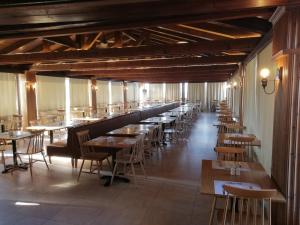 a row of tables and chairs in a restaurant at Hersonissos Village Hotel & Bungalows in Hersonissos