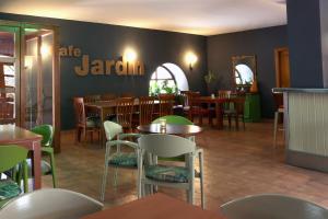 a restaurant with tables and chairs and a sign on the wall at Hospedería Sádaba in Sádaba +13 photos