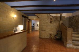 a hallway in a building with a stone wall at Hospedería Sádaba in Sádaba