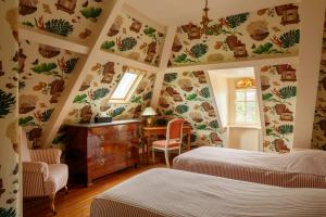 a bedroom with two beds and a desk in it at Chateau de Servigny in Yvetot Bocage