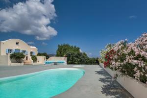 a villa with a swimming pool and flowers at Sienna Eco Resort in Fira