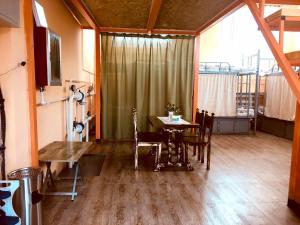 a dining room with a table and chairs in a room at Danista Nomads Tour Hostel in Ulaanbaatar