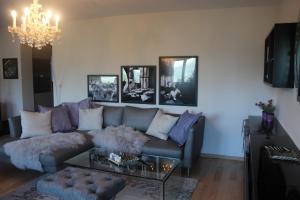 a living room with a couch and a chandelier at Villa Falkner in Tirolo