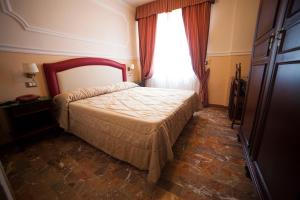 Postel nebo postele na pokoji v ubytování Hotel Gran Duca