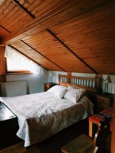 a bedroom with a large bed with a wooden ceiling at Ptaszorowka in Szczyrk