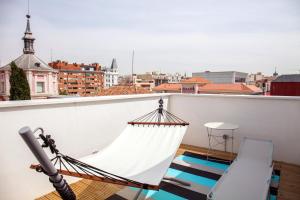 a patio area with a surfboard and a bench at Bastardo Hostel in Madrid
